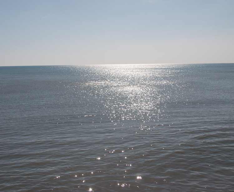 Sun sparkling on the sea at West Bay 